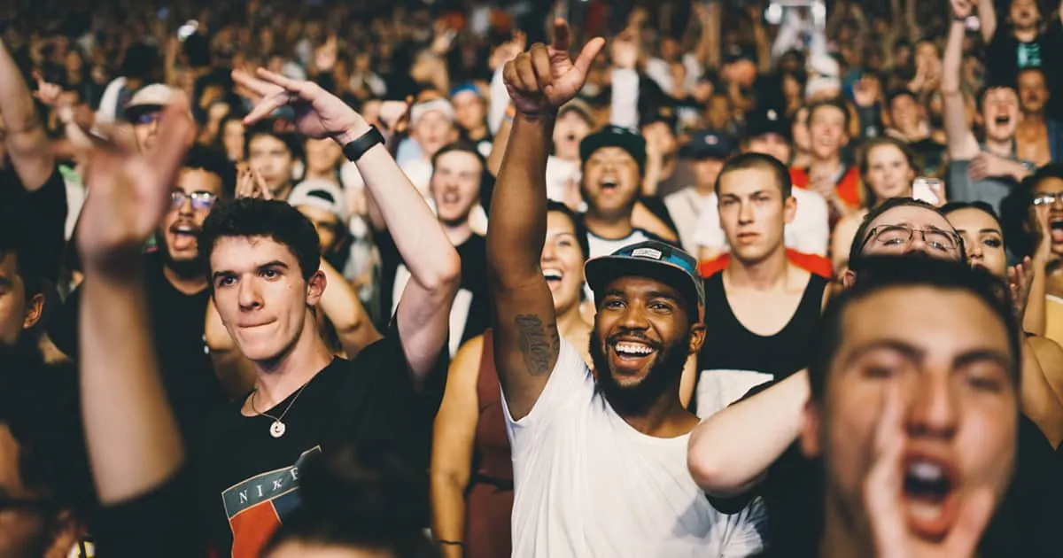 Vibrant crowd enjoying live music concert, demonstrating audience engagement and entertainment at a popular music event.