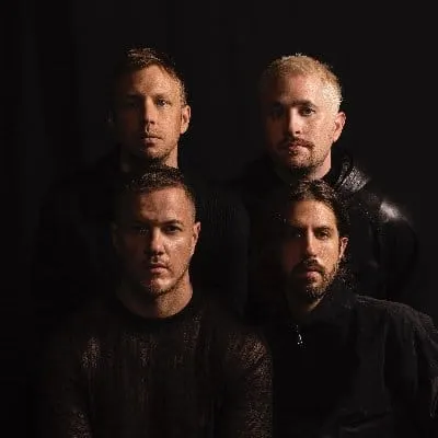 A talented music band posing together in a professional photo shoot, emphasizing their cohesive group dynamic and stylish bla