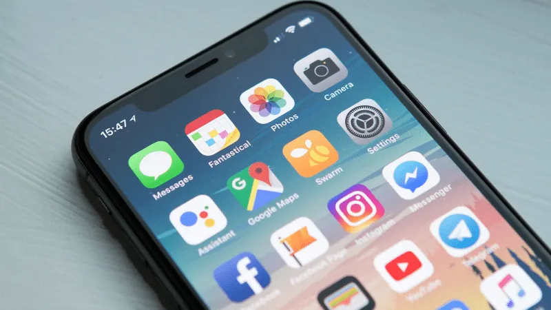 Smartphone displaying popular social media and productivity apps, including Facebook, Instagram, Google Maps, and Messenger,